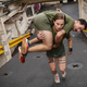 Marines have to be able to carry one another if necessary. USMC Cpl. Gabrielle Green hefts a fellow marine as they ready for deployment on a Navy ship at Camp Lejeune, North Carolina. Of the 38,000 recruits who enter the corps each year, about 3,500 are women—or, in USMC phrasing, “female marines.”
